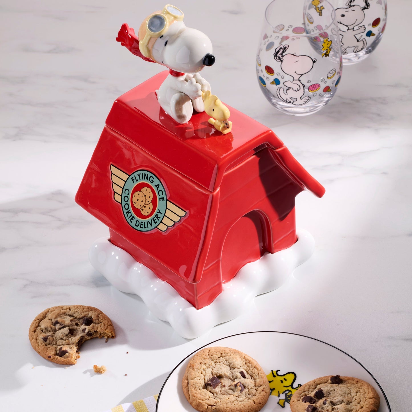 Red cookie jar with Snoopy design on a white surface
