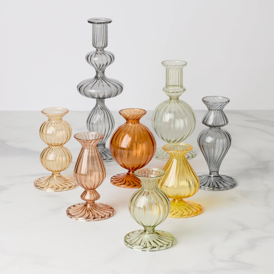 Set of colorful glass vases on a white surface
