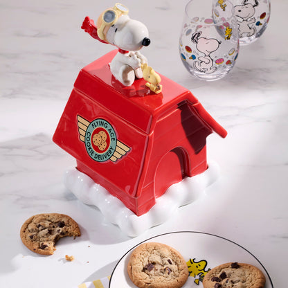 Red cookie jar with Snoopy design on a white surface