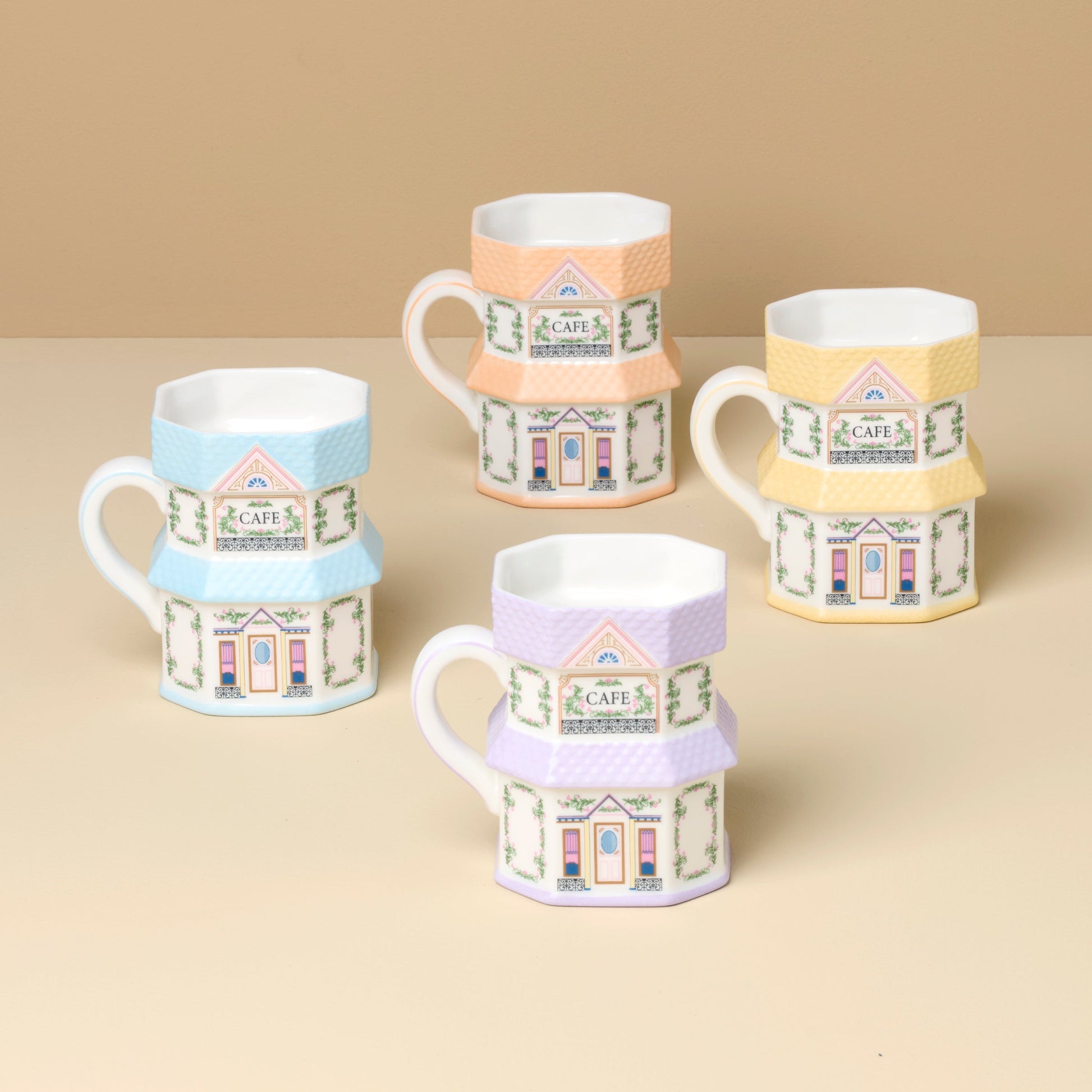 Set of decorative mugs with house designs on a beige background