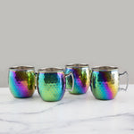 Four iridescent mugs on a marble surface with a white background